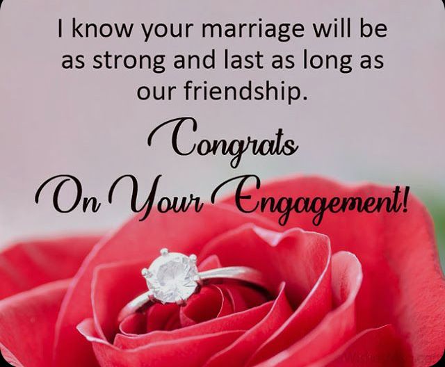 A joyful couple celebrating their engagement with friends A joyful couple celebrating their engagement with friends