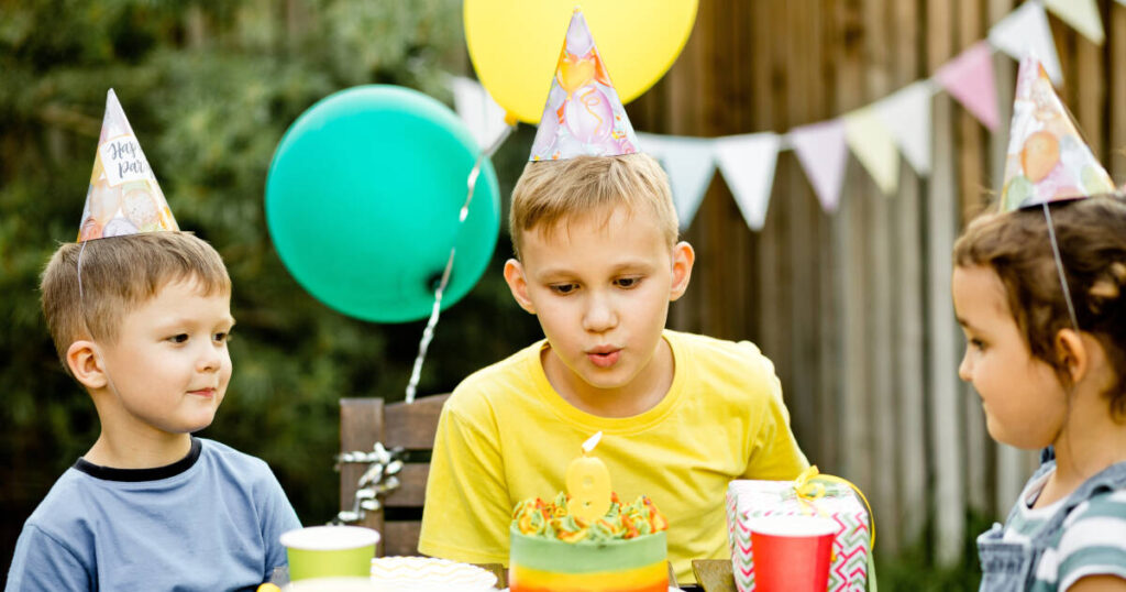 Smiling boy holding a birthday cake with lit candles Smiling boy holding a birthday cake with lit candles